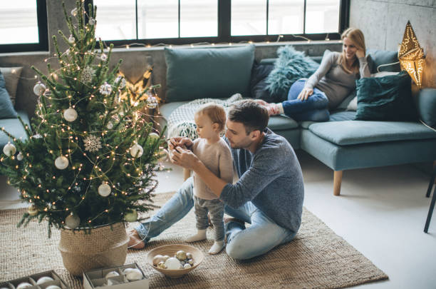 Father and daughter decorate a christmas tree | Design Waterville